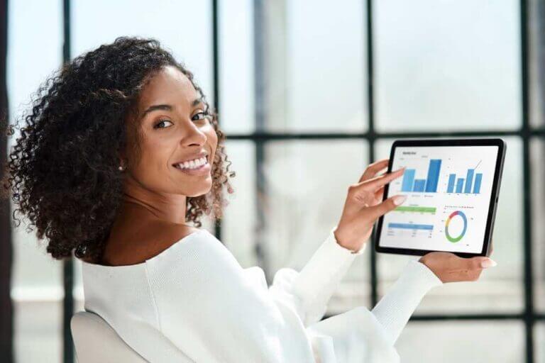 Smiling,Business,Woman,With,A,Digital,Tablet,Looking,At,The