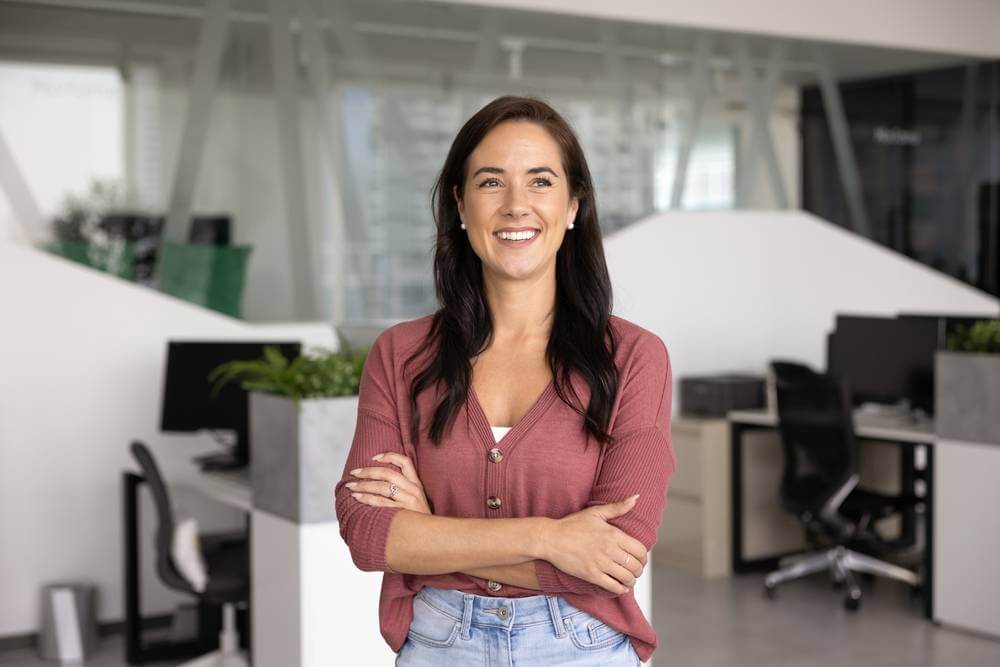 Portrait,Of,Happy,Woman,Posing,With,Arms-crossed,In,Contemporary,Co-working