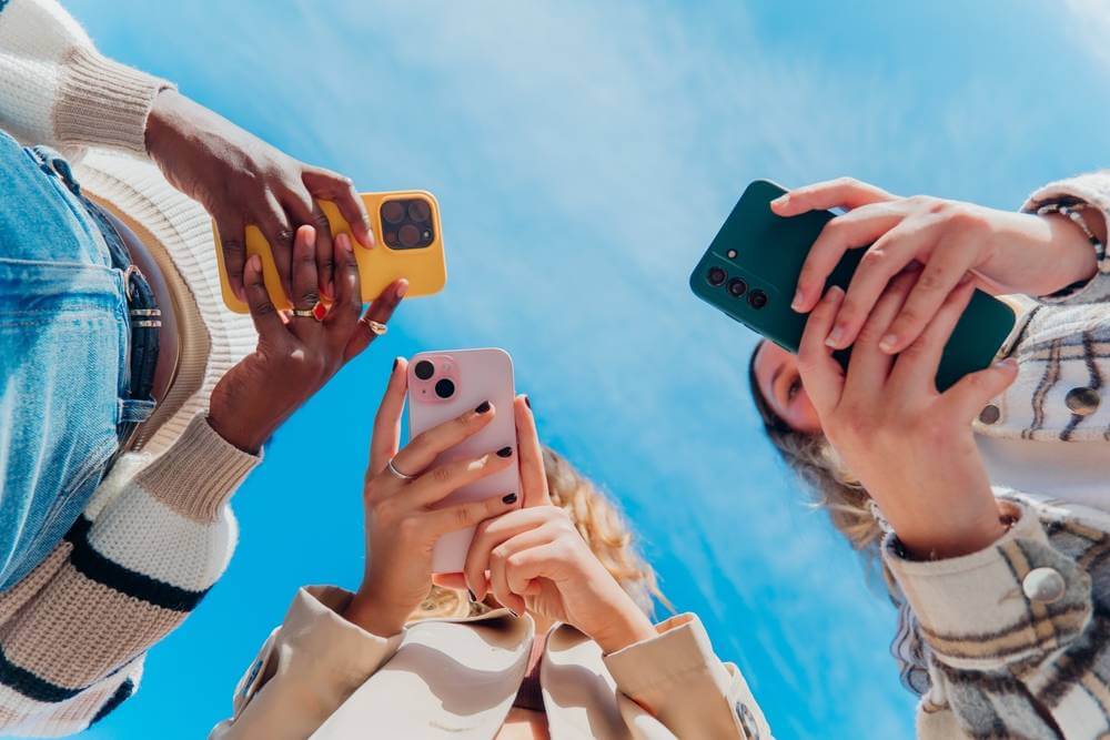 Diverse,Young,People,Are,Holding,Up,Mobile,Phones,,Capturing,Content