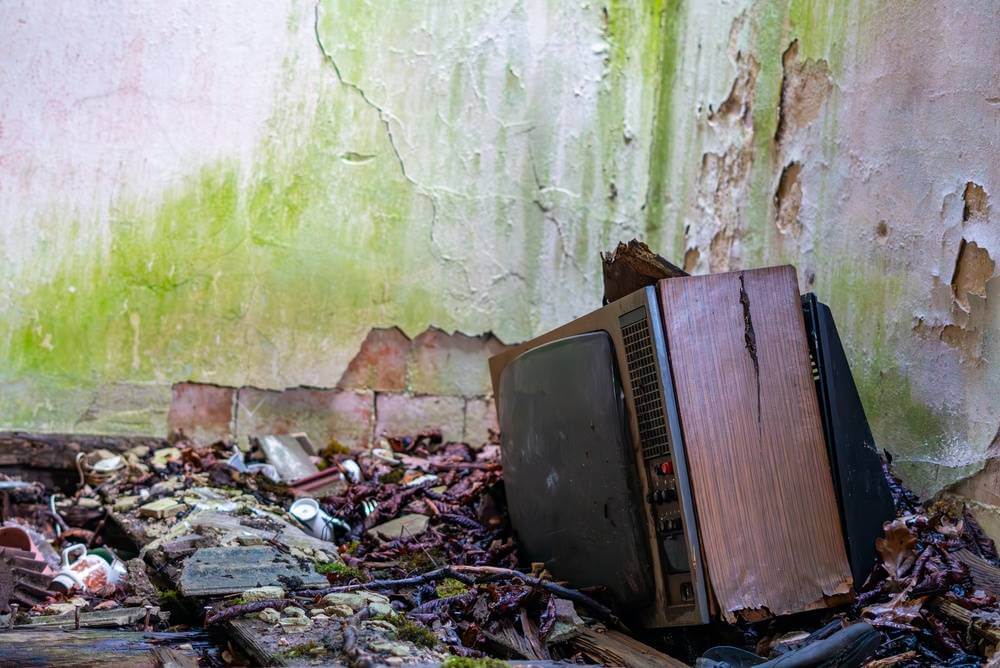Old,Damaged,Wooden,Crt,Television,Set,Left,On,A,Debris-filled